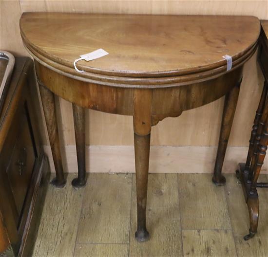 An 18th century mahogany triple folding tea / card table W.75cm